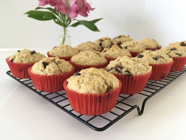 Oatmeal Chocolate Chip Muffins on cooling rack with flowers