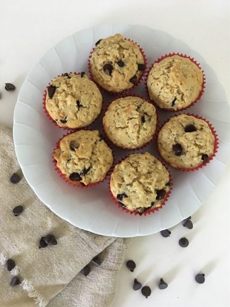 Oatmeal Chocolate Chip Muffins with sprinkled chocolate around plate