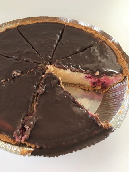 Raspberry Cheesecake Pie with slice cut out