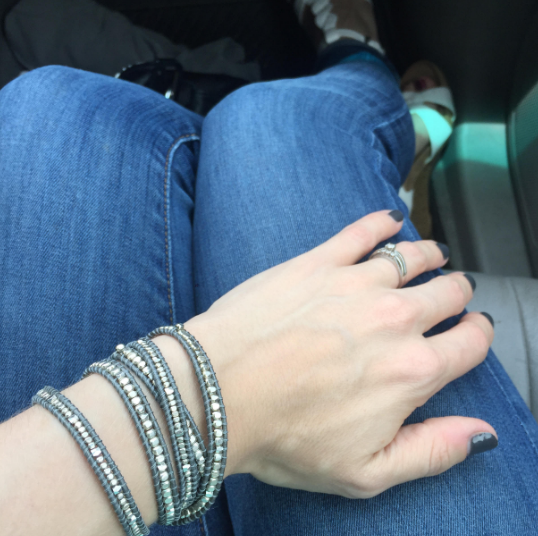 wrap bracelet on wrist resting on pants