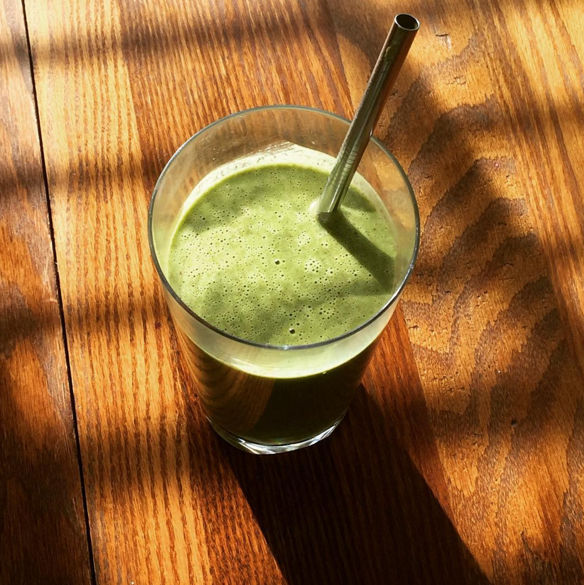 banana green smoothie on wooden table
