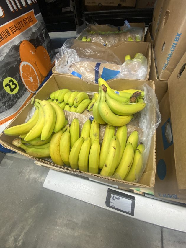 Box of bananas in the produce aisle with a price tag reading "0.49" per pound.