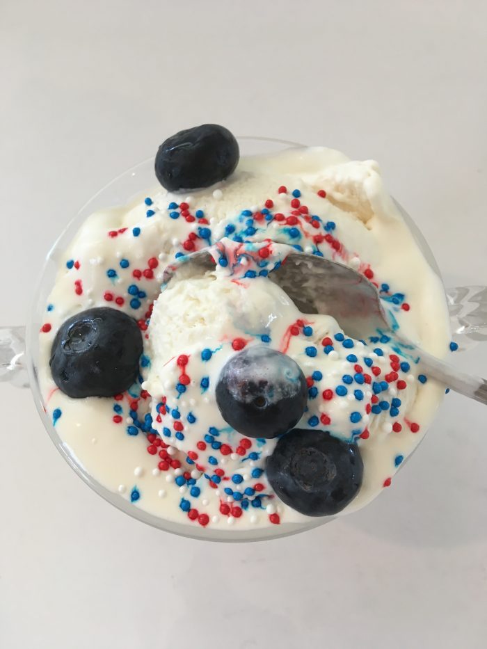 4th of July ice cream dessert with blueberries and patriotic sprinkles