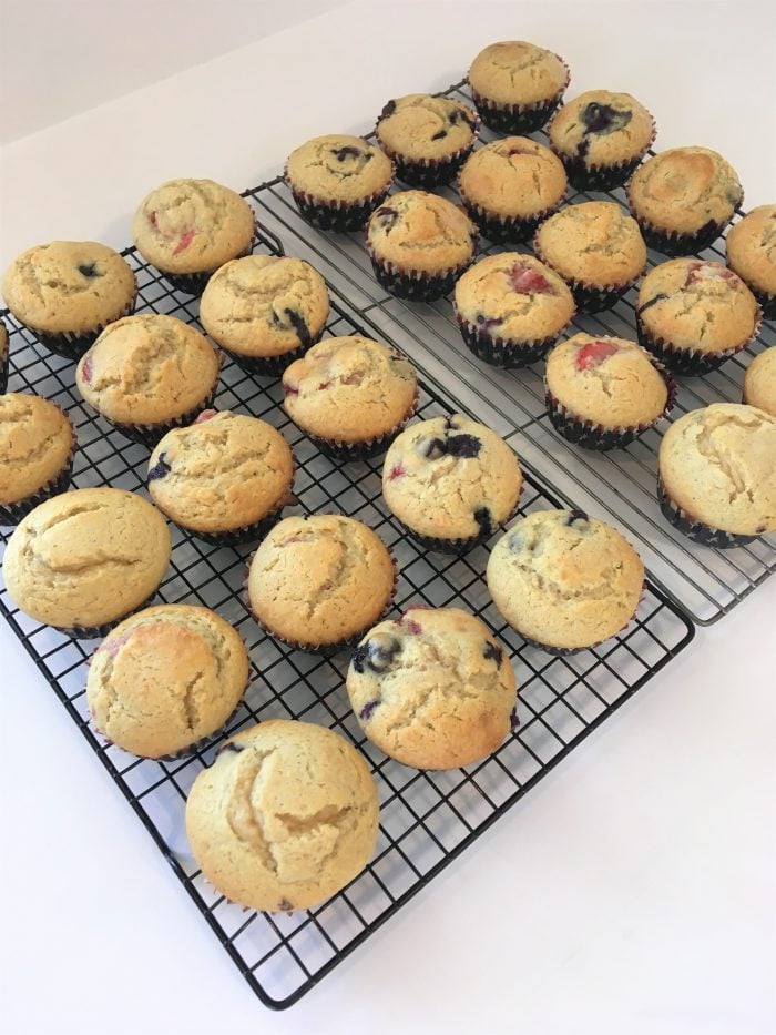 baked blueberry and strawberry muffins on cooling racks