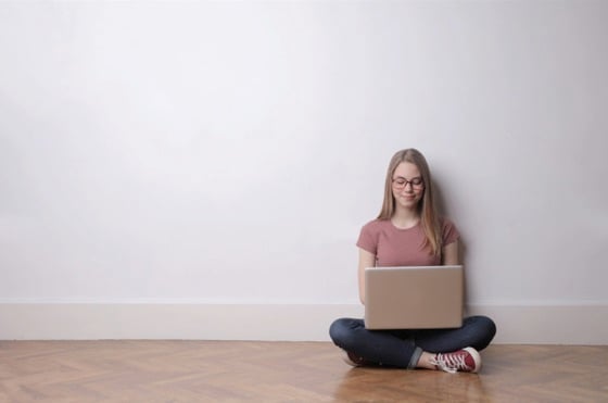 Girl on Computer in Empty Room