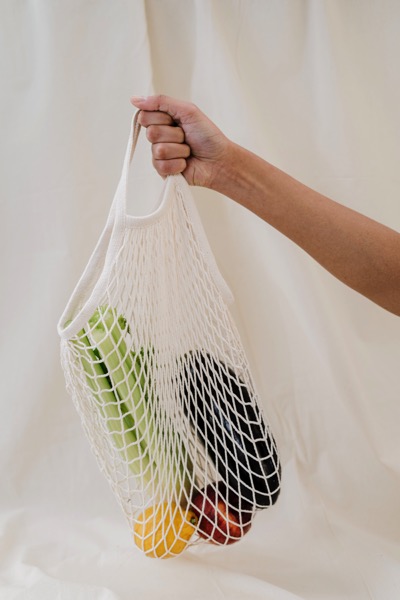 Person holding produce bag