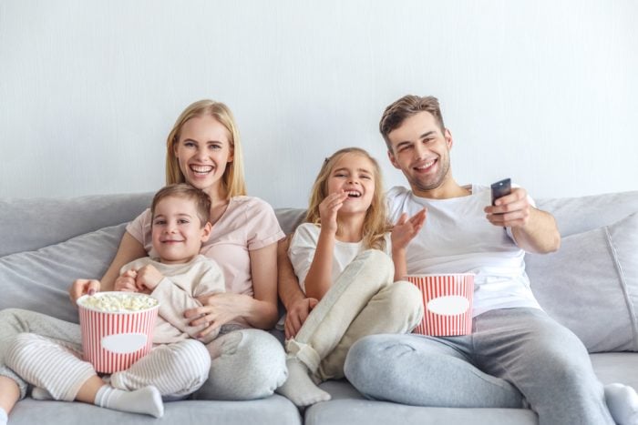 family having a movie night on the couch with popcorn