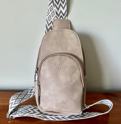 Cluci Small Sling Bag in Gray on dresser