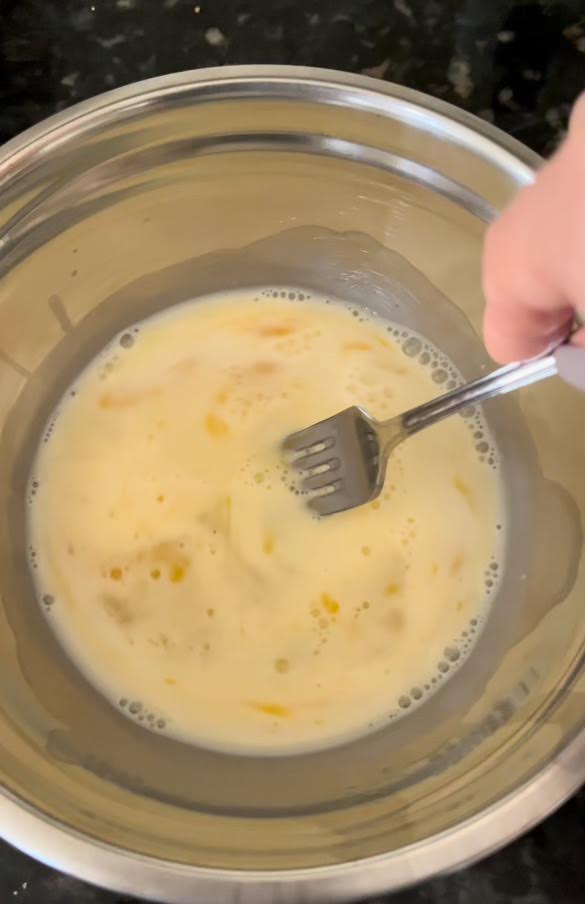 Preparing the egg mixture for cooking