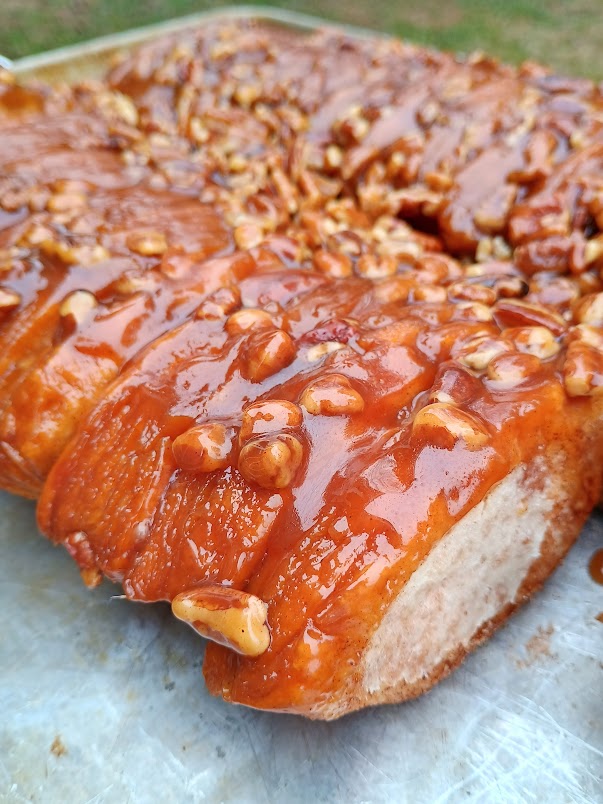 Freshly baked monkey bread covered in glossy caramel and pecans.