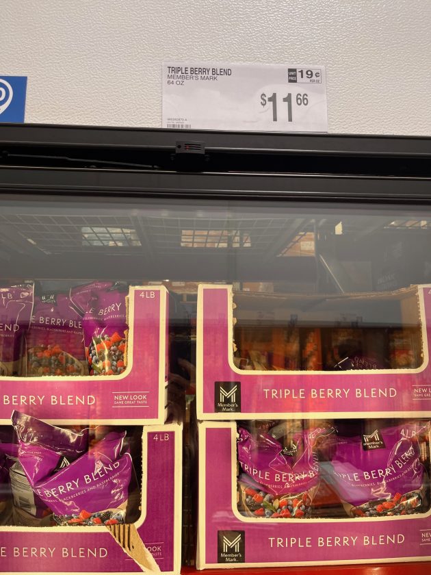 Freezer case filled with bags labeled "TRIPLE BERRY BLEND" with a price sign above reading "$11.66" and packaging marked "4 LB."