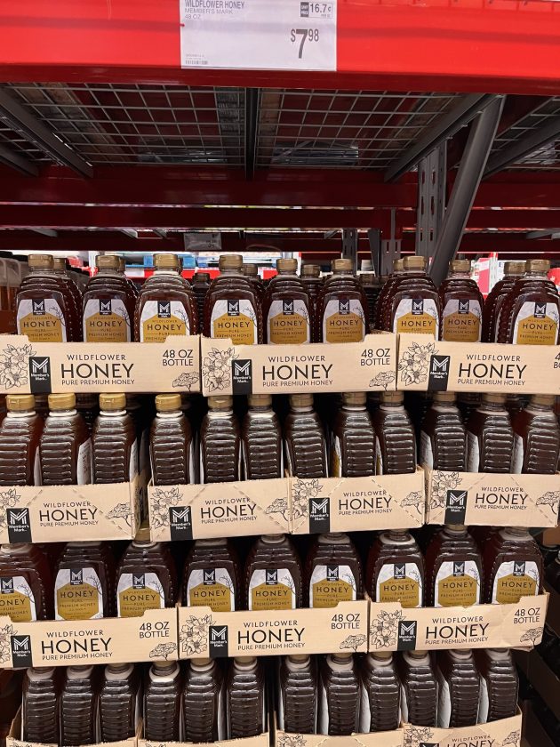 Bulk display of bottles labeled "WILDFLOWER HONEY 48 OZ BOTTLE" are one of the best things to buy at Sam's Club. A price sign hangs above reading "$7.98." 