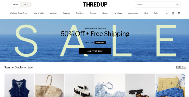 ThredUp homepage promoting a Memorial Day sale with the text "50% Off + Free Shipping" above featured secondhand clothing and accessories. The online reselling app specializes in affordable pre owned fashion for women and kids.
